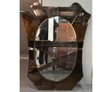 An Art Deco oval glass mirror, with peach glass surround, height 120cm, width 96cm.