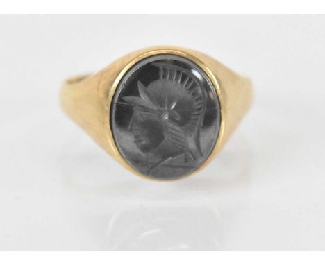 A 9ct yellow gold intaglio set signet ring (cut), the intaglio carved as a warrior, approx 5.3g.