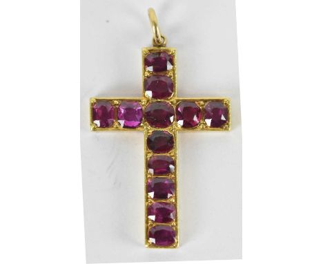 A yellow metal ruby set crucifix pendant set with twelve small rubies totalling approx 1ct, 2.5 x 2cm, approx 3.5g.