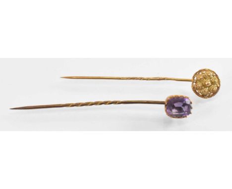 A 9ct yellow gold amethyst set stick pin and a yellow metal stick pin, combined approx 2.3g.