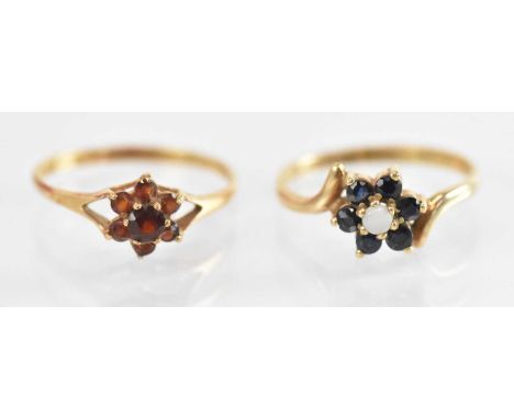 A 9ct yellow gold garnet set ring, size N, and a 9ct yellow gold opal set ring, size M, combined approx 2.7g.
