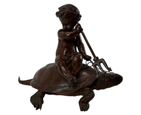 A late 19th century bronze model of a cherub sitting on a tortoise holding a pitchfork, height 13.5cm, length 20cm.