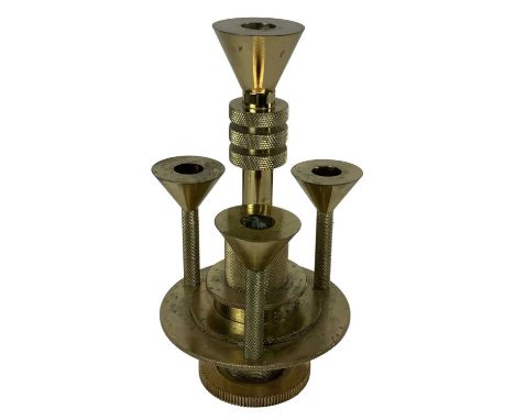 THOMAS DIXON OF LONDON; a brass industrial style four branch candlestick, height 27.5cm.