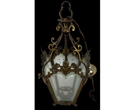 An ornate brass four sided lantern with glass inserts, height 46cm and a set of four Regency style brass wall mounted curtain
