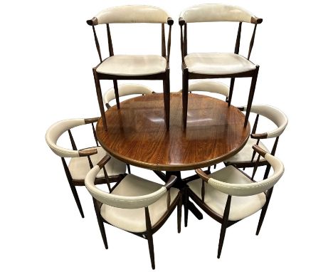 A 1970s rosewood circular extending dining table, diameter 120cm, and eight upholstered rosewood chairs. (CITES application n