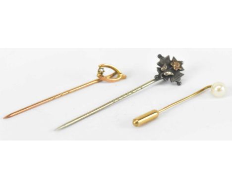 A yellow metal stick pin, a yellow metal seed pearl set pin and a small white metal pin, combined approx 2.6g (3).