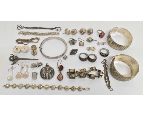 A group of silver and white metal jewellery, including two 925 hallmarked silver pinch bangles, a hallmarked silver bangle, a