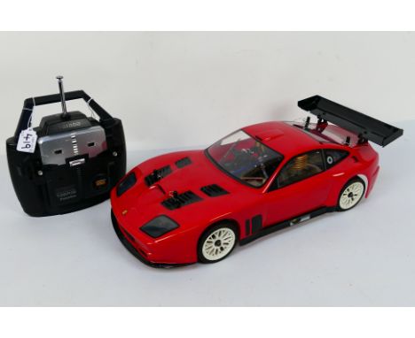 Kyosho - An unboxed Kyosho 1:10 scale nitro RC Ferrari 575 GTC. The chassis underside has a few scratches but overall the cha