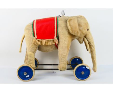 Steiff - A vintage Steiff Ride On Elephant. The blond mohair elephant measures approximately 90 cms (trunk to tail - with tai