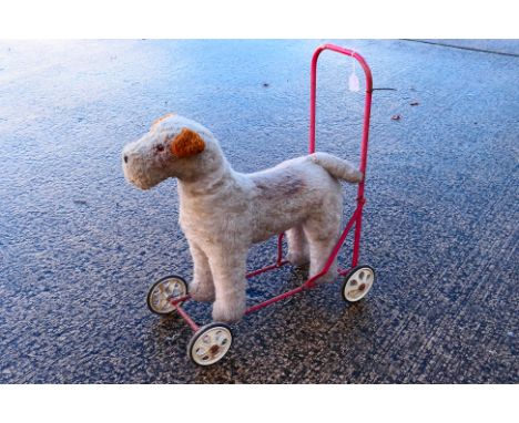 Wylena - A push along Terrier dog from Wylena. The dog is labeled to underside and shows age wear and signs of play appearing