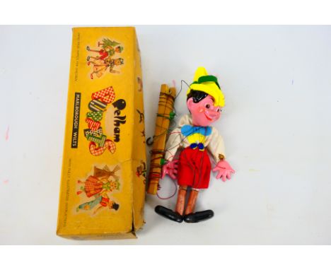 Pelham Puppet's - Pinocchio. A 'candy strip' boxed Pelham Puppets Pinocchio Puppet, with painted composite head and limbs. St