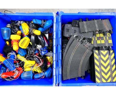 Scalextric - Two plastic containers one of which is packed with a large quantity of Scalextric controllers and several transf