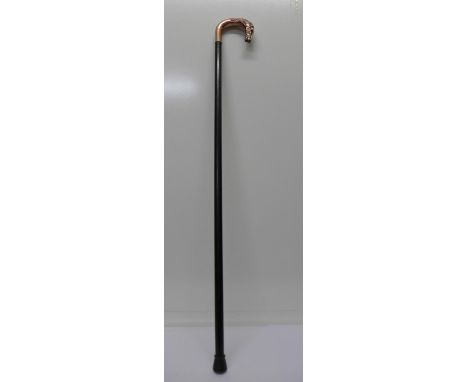 A walking stick with horse's head handle