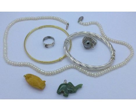 A silver bangle, a silver gilt bangle, a freshwater pearl necklace, two silver rings and two pendants