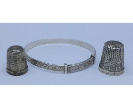 A Charles Horner silver thimble, one other silver thimble and a silver bangle