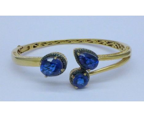 A bangle set with blue stones
