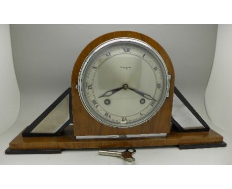 A walnut cased Art Deco mantel clock with striking movement, the movement marked Empire De Luxe, the dial marked Dickinson, B