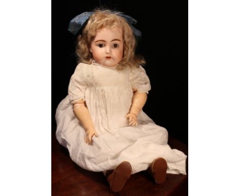 A Kämmer &amp; Reinhardt (Germany) bisque head and ball jointed painted composition bodied doll, the bisque head with weighte