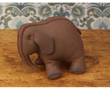 A novelty miniature grey felt Elephant, in the 'Folk Art' manner, amber and black plastic eyes, blue stitched detail to the e