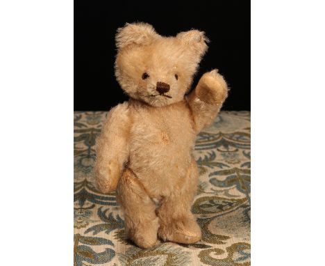 A 1950's Steiff (Germany) blonde mohair jointed miniature teddy bear, brown and black plastic eyes, pronounced snout with ver