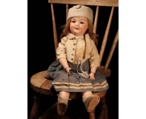 An Armand &amp; Marseille (Germany) bisque head and ball jointed painted composition bodied doll, the bisque head with weight