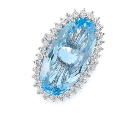 A BLUE TOPAZ AND DIAMOND CLUSTER RING set with an oval cut blue topaz of 23.81 carats, within a border of round brilliant cut