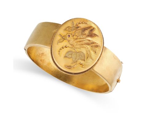 NO RESERVE -&nbsp;AN ANTIQUE RUBY LOCKET BANGLE the oval face depicting a bird amongst foliage, accented by a cabochon ruby e