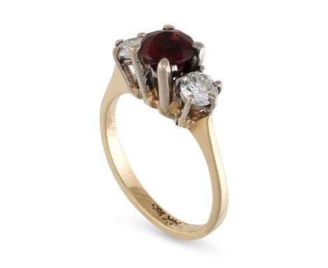 A VINTAGE GARNET THREE STONE RING in 14ct yellow gold, set with a round cut garnet between two round cut cubic zirconia, stam