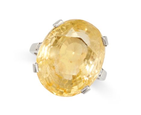 A CEYLON NO HEAT YELLOW SAPPHIRE AND DIAMOND RING set with an oval mixed cut yellow sapphire of 27.97 carats, accented by rou