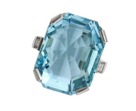 AN AQUAMARINE AND DIAMOND RING in 18ct white gold, set with an emerald cut aquamarine of 6.26 carats, accented by round cut d