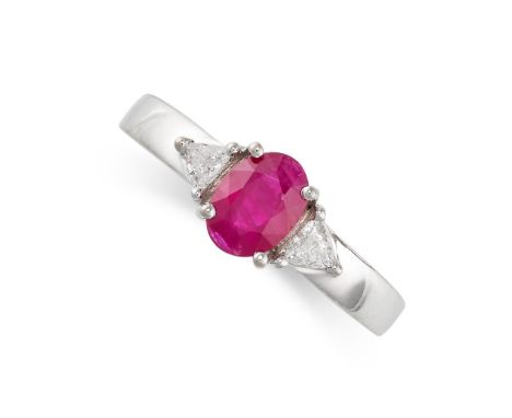 A RUBY AND DIAMOND THREE STONE RING in 18ct white gold, set with an oval cut ruby of approximately 1.00 carat, between two tr