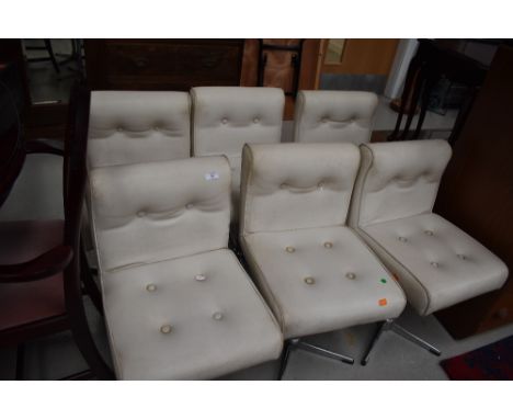 A set of six vintage vinyl chairs on chrome swivel bases