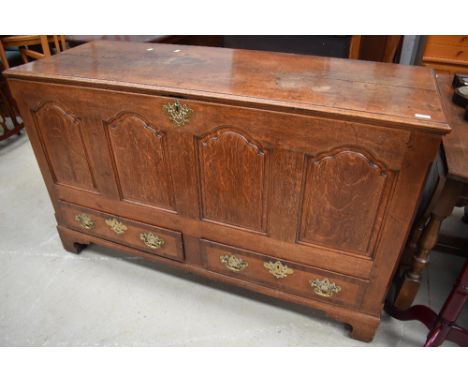 A Georgian oak 4 panel kist having drawer base, brass handles and escutcheons, bracket feet, dimensions approx. W146 D54 H90c