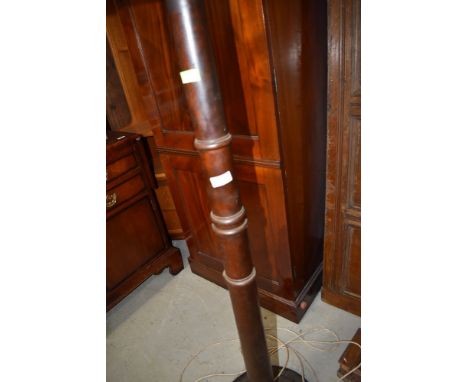 A mahogany standard lamp having turned column
