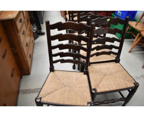 A set of six traditional rush seated ladder back chairs
