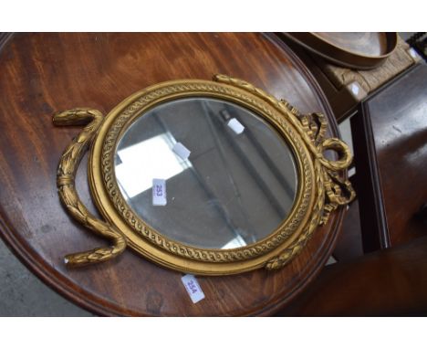 A vintage reproduction gilt plaster wall mirror of smal proportions, having swag decoration, bears label 'Beau Brummel' width