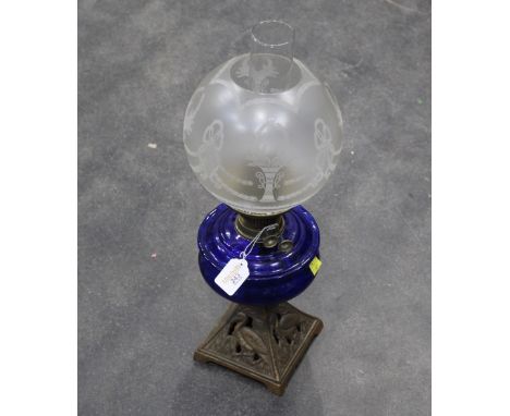 Vintage oil lamp with blue glass reservoir 