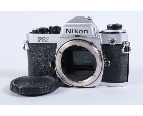 A Nikon FE2 Camera body, chrome, serial no 2023038, shutter working, meter responsive, self timer working  body G, paint wear