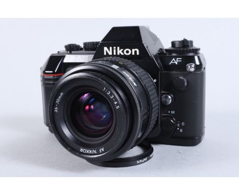 A Nikon F 501 SLR Camera, serial no 5193669, powers up, shutter working, appears to function as should, some signs of perviou