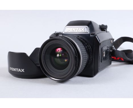 A Pentax 645n Camera, serial no 6729870, powers up, appears to function as should, shutter working, body G, some light scratc