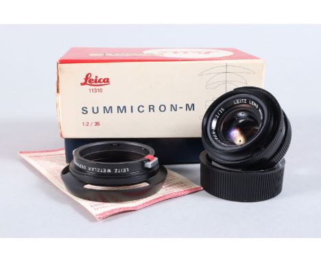 A Leica Summicron M 35mm f/2 Lens, black, made in Canada, serial no 3018507, 1980, barrel G-VG, elements G, light haze, with 