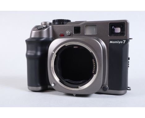 A Mamiya 7 Camera Body, PB1161, powers up, LED display working, lens tested, shutter fires on all speeds, body G, light wear