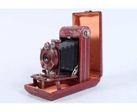 A Kodak Vanity Series III Vest Pocket Camera, red, shutter working, body G-VG, some light wear to edge of lens door,bellows G