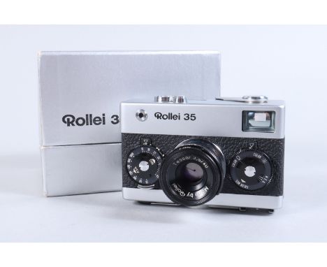 A Rollei 35 Compact Camera, made in Singapore, shutter working, meter responsive, evedence of previous battery damage in cham