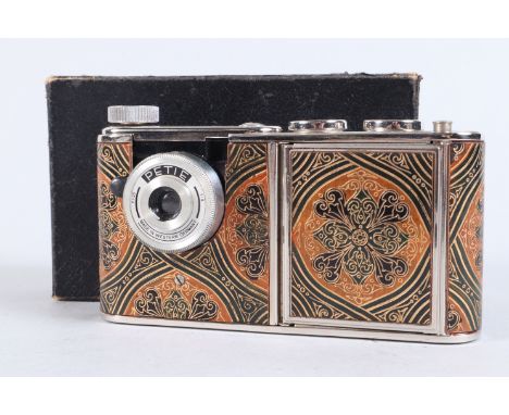 A Walter Kunik Petie Vanity Camera, chrome, gold, brown green, black design, case VG, with powder compact, lipstick holder, u