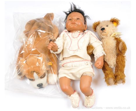 Steiff pair and a vinyl doll: (1) Steiff Classic teddy bear, yellow tag 001000, cappuccino beige and brown two-tone, with swi