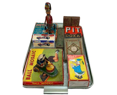 Collection of vintage toys including clockwork cycling duck, drumming panda, racing car and reading duck and various games.