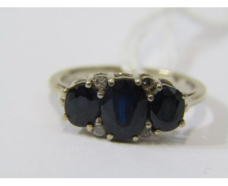 SAPPHIRE &amp; DIAMOND RING, 3 stone sapphire ring indispersed by 4 diamonds on an 18ct yellow gold band, size L 