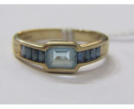 9ct YELLOW GOLD TOPAZ &amp; SAPPHIRE RING, principal pale blue topaz with dark blue sapphires set to each shoulder, size R/S 