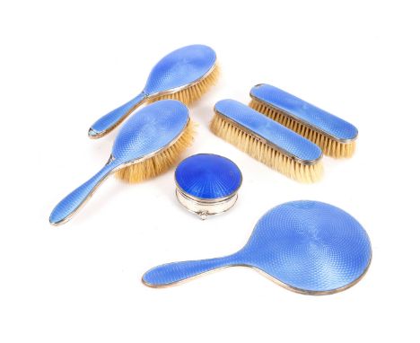 A George V six-piece silver and blue enamel dressing table set, Walker & Co., Birmingham 1927, comprising two clothes brushes